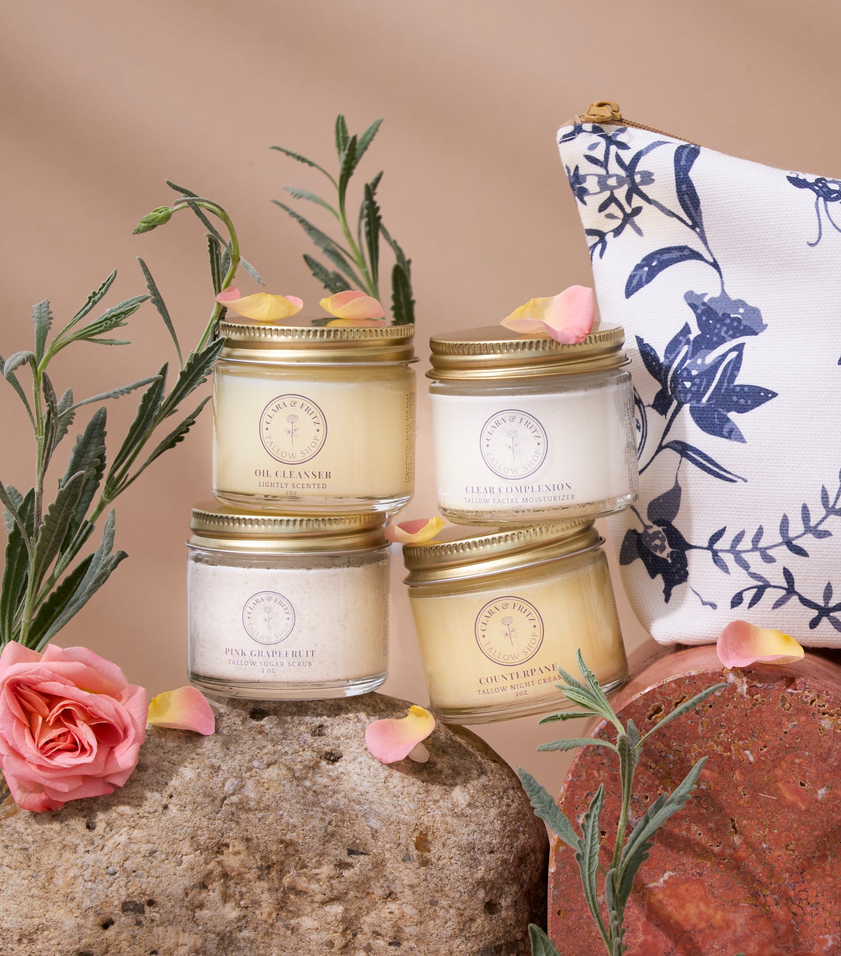 Four candles with gold lids on a textured surface with flowers and a floral-patterned bag. 100% grass-fed beef tallow, *extra virgin olive oil, geranium bourbon oil, pink grapefruit oil, himalayan cedarwood oil, peppermint oil, rosemary oil, roman chamomile oil; *certified organic
Clear Complexion is petroleum free, paraben-free and contains no dyes or artificial fragrances. It is safe for use on sensitive skin, and can be used daily to help prevent breakouts. 
