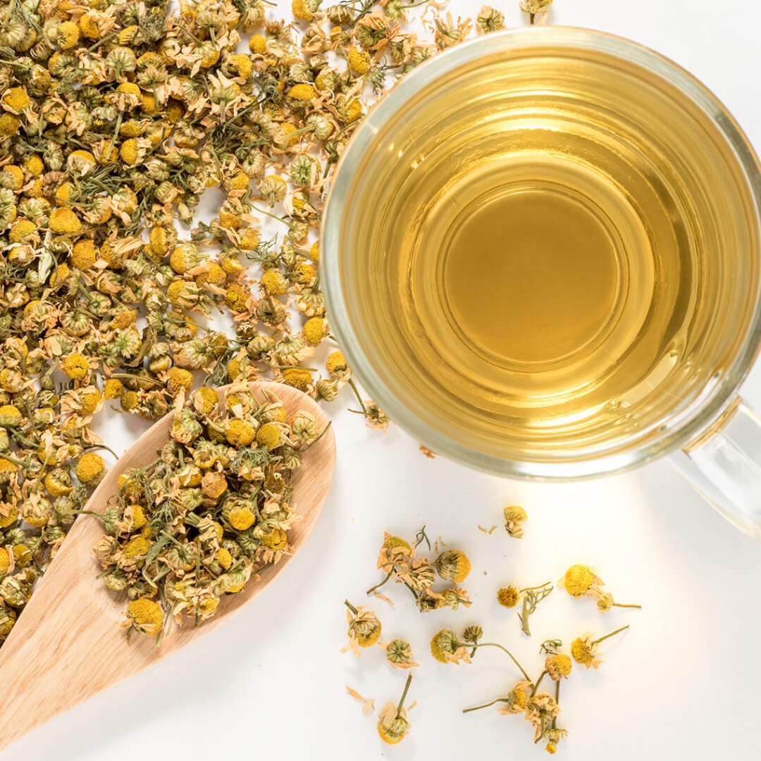 Glass of chamomile tea with dried chamomile flowers and a wooden spoon on a white background. Box of Greek Superherbs Organic Chamomile Tea surrounded by chamomile flowers. Pure whole flowers from Grevena, Greece. The most potent, honey-sweet chamomile you will ever taste.
Type: Matricaria Chamomilla
Ingredients: Organic chamomile flowers.Chamomile tea is one of the most well-supported herbal teas for health, with measurable benefits for slee