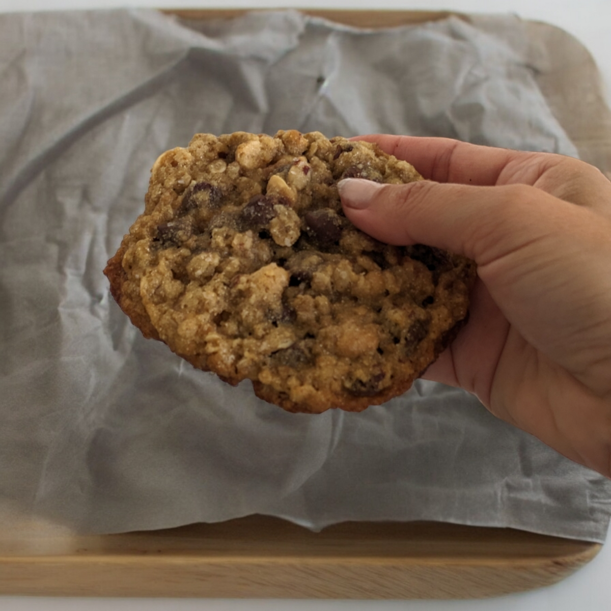 Bag of organic wellness cookies with cookies in front on a white background. high protein and all natural workout bars