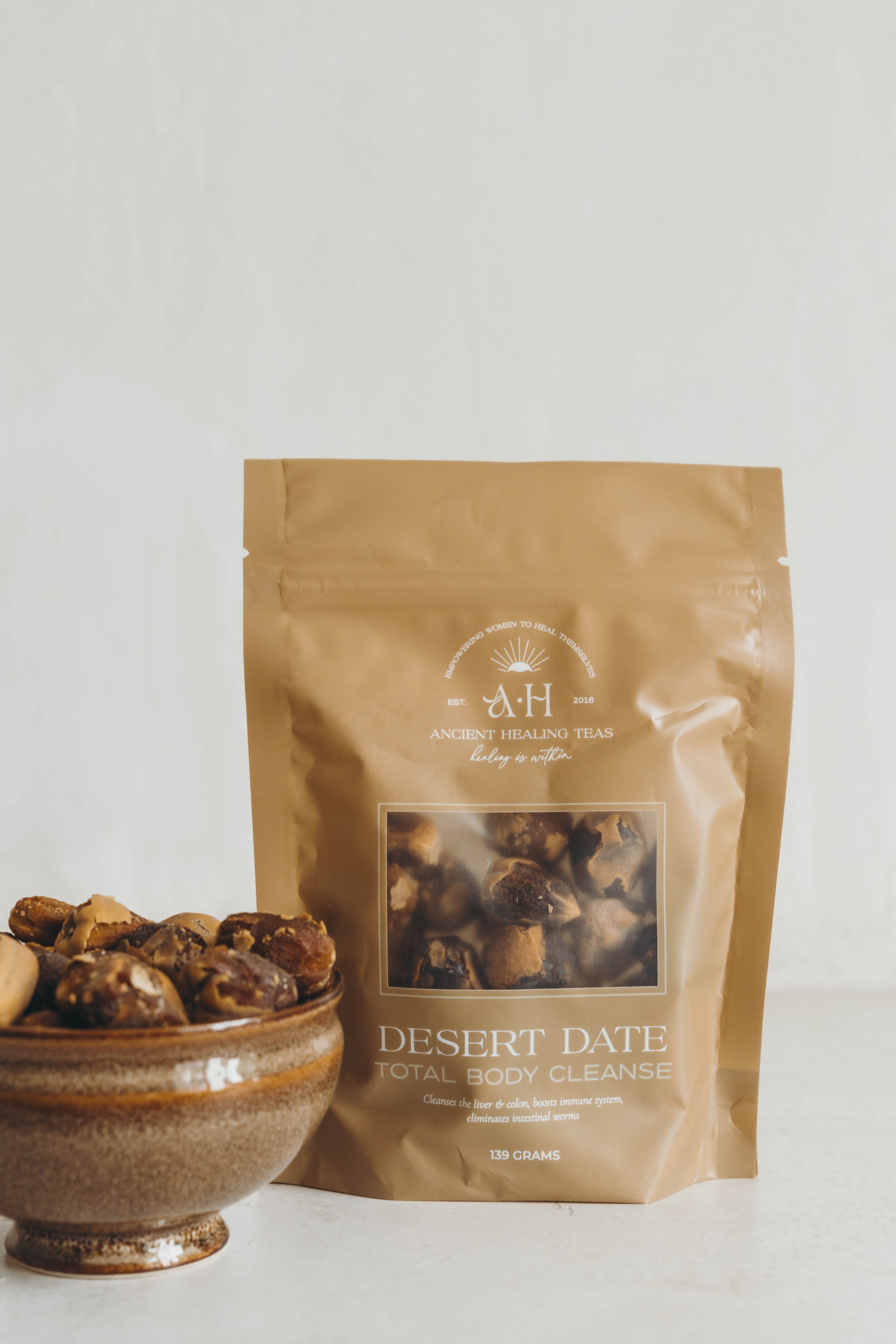 Bag of desert date tea with a bowl of dates on a white background. This herbal support gives the body a total detox by:


Helping purge waste, toxins, and poisons from the system
Relieving constipation
Reducing candida in the body
Is known to help rid the body of worms and parasites
Increasing iron absorption
Lowering inflammation
Promoting healthy skin