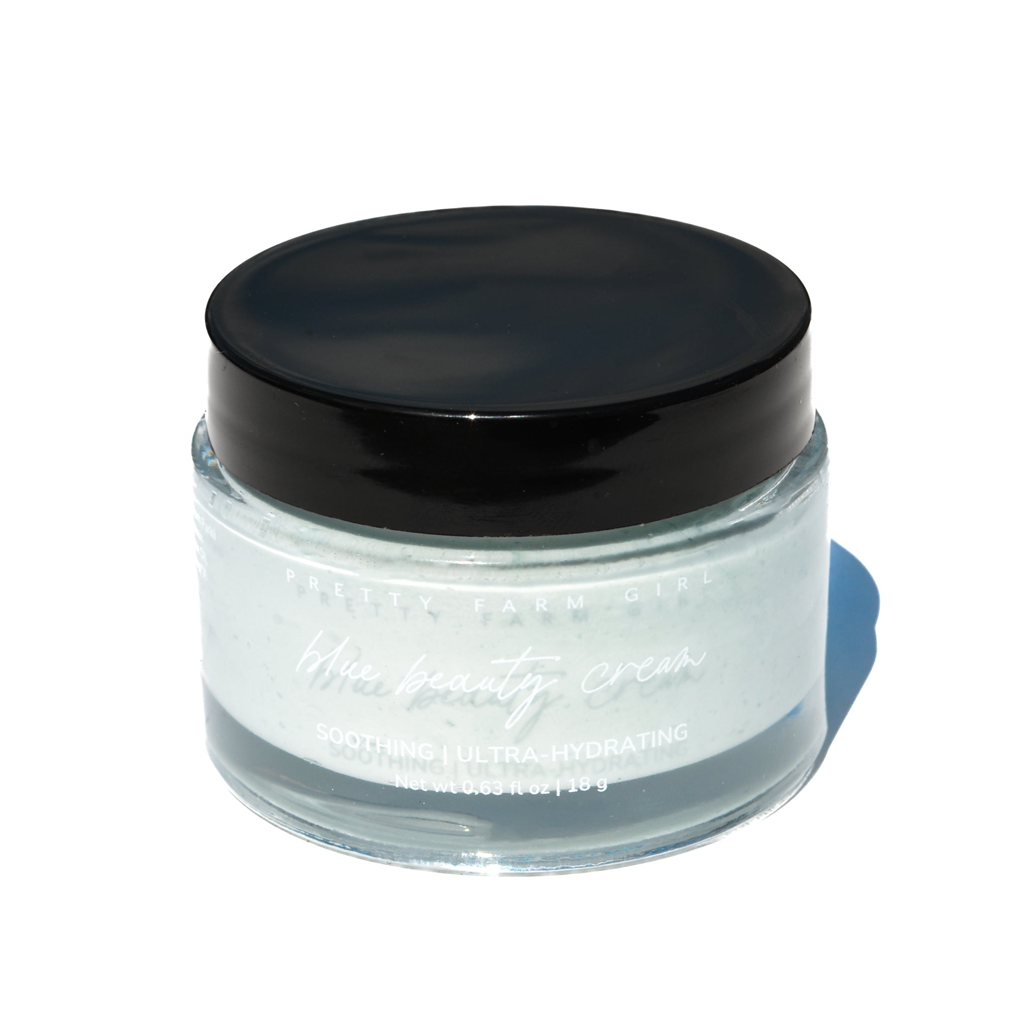 Glass jar with black lid on a white background. Skincare jar with a blurred natural background. organic natural facial moisturizer and skin nourishing with probiotics and vitamin c tallow