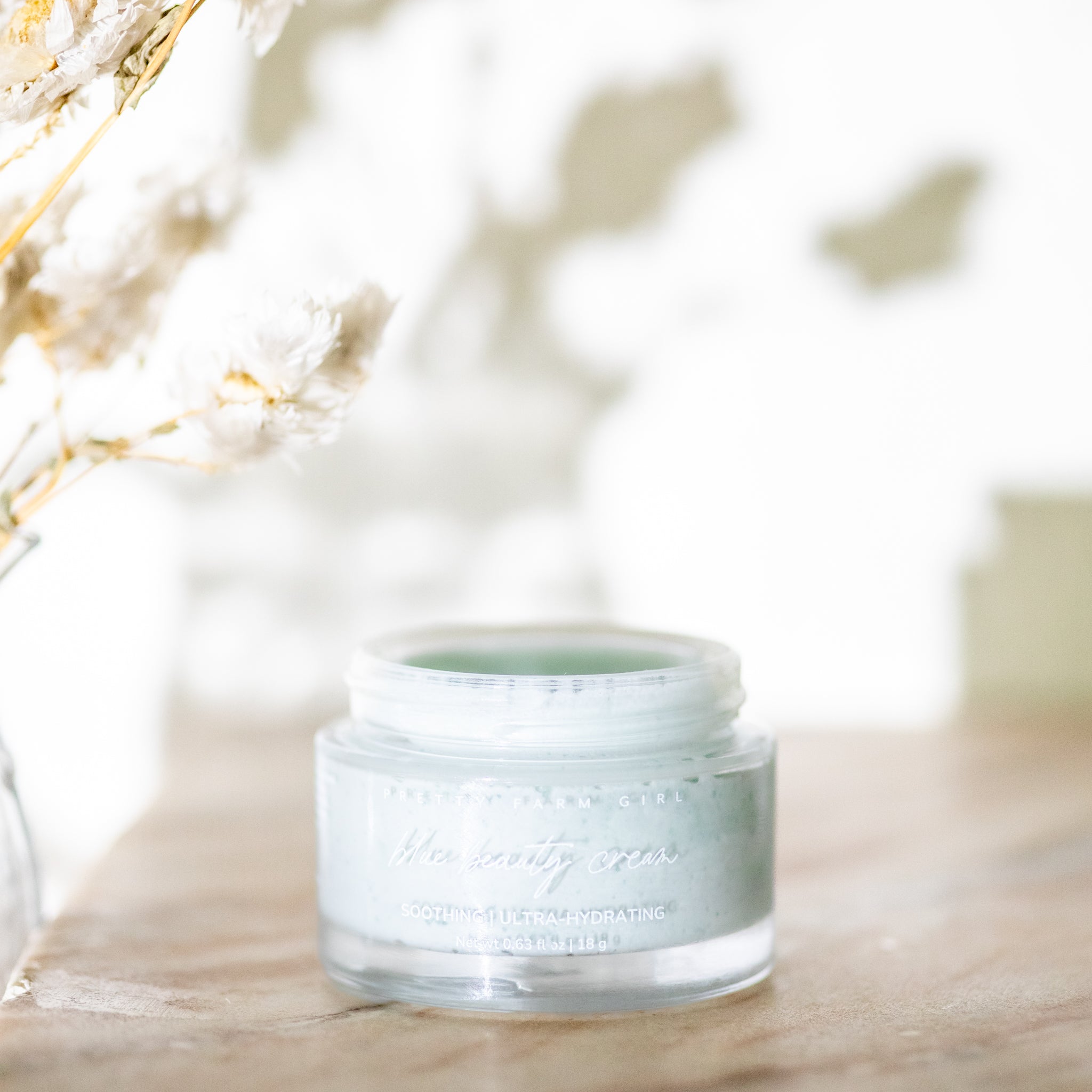 Skincare jar with a blurred natural background. organic natural facial moisturizer and skin nourishing with probiotics and vitamin c tallow