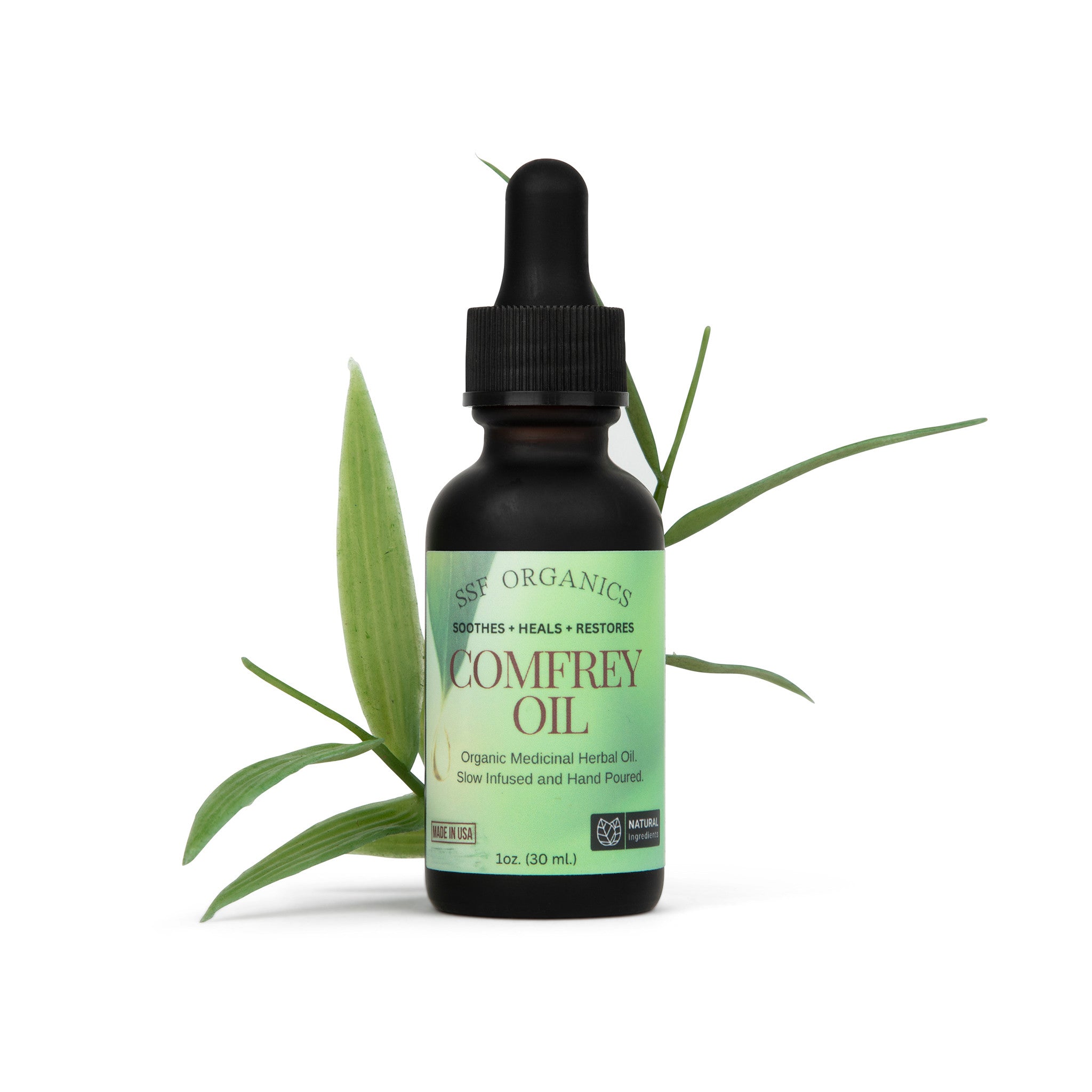 Bottle of comfrey oil with a dropper on a white background