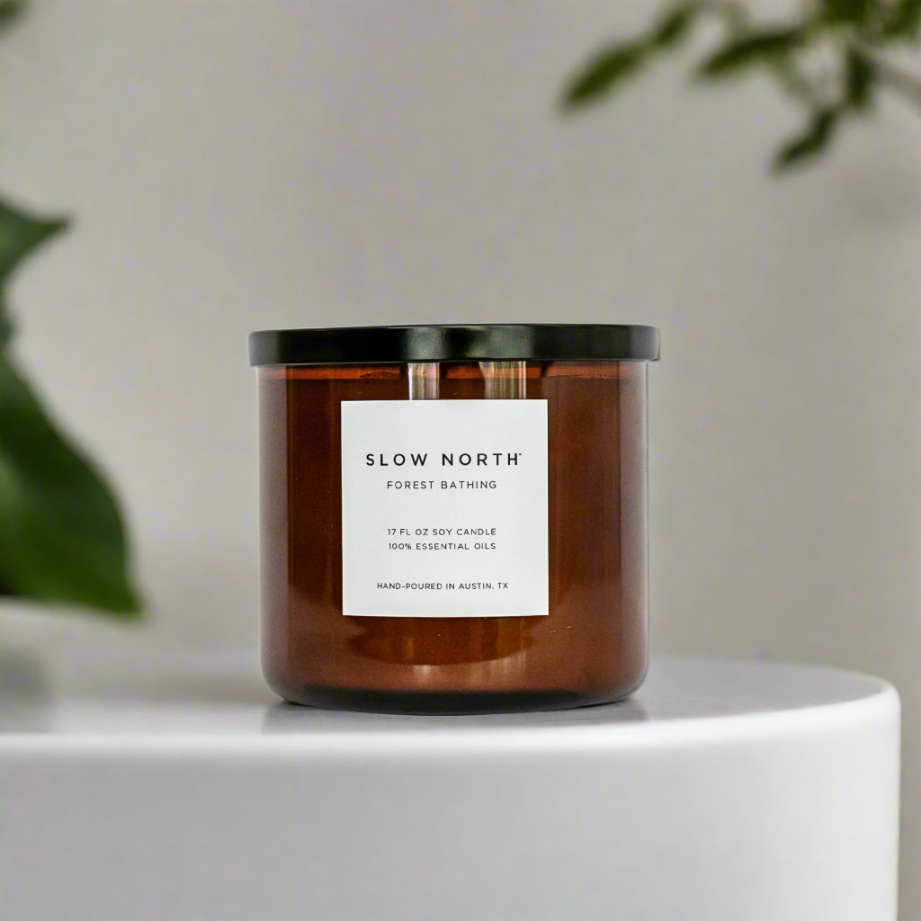 Candle with a label on a white surface with a blurred background
Hand-poured in Austin, Texas, this candle is made with 100% soy wax and pure essential oils. 