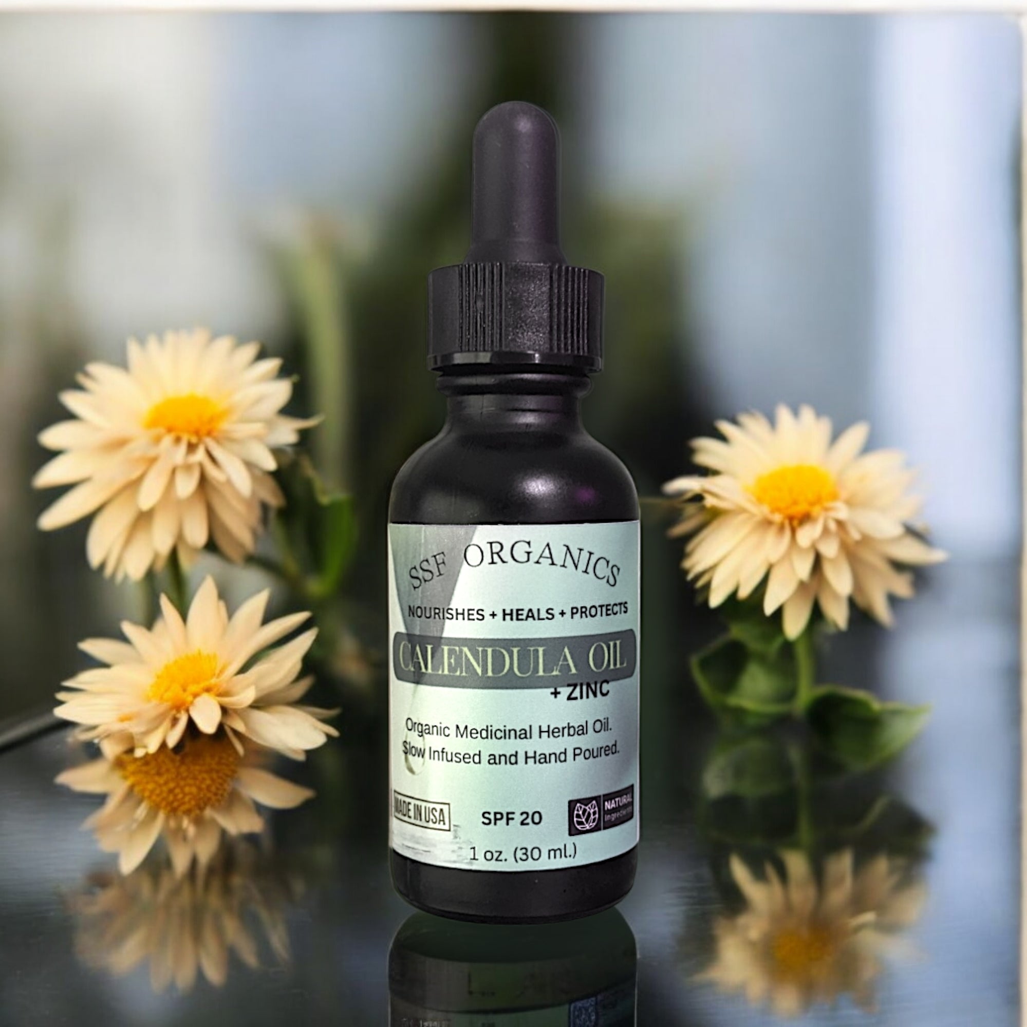 Bottle of calendula oil with packaging and dried calendula flowers. natural herbal skin oil acial oil plant healing aloe vera