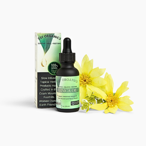 Organic Arnica Oil bottle with packaging and yellow flowers on a white background