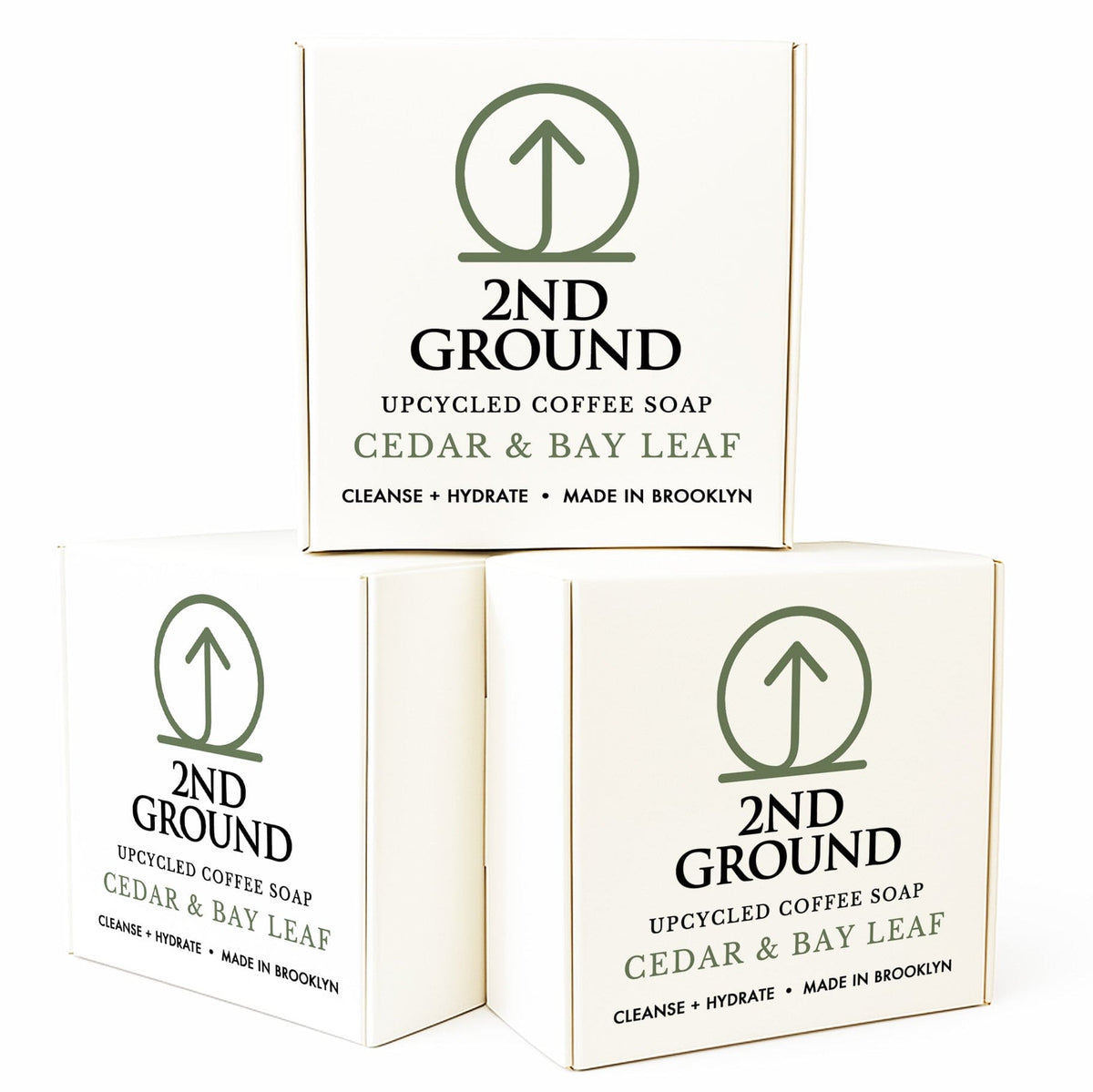 Three boxes of 2nd Ground upcycled coffee soap with cedar and bay leaf scent on a white background. Collection of 2nd Ground upcycled coffee soap bars on a stone surface with branded boxes. comfrey salve for healing arthritis workout recovery drawing salve