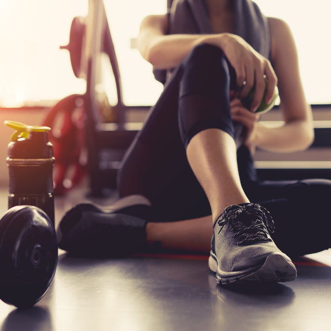 Person sitting on a gym floor with exercise equipment around. post surgery workout and joint care. Person meditating with hands in prayer position over sunset at beach. natural healing and topical recovery and relief from arthritis, psoriasis, and eczema. Treats with medicinal herbs like comfrey calendula | arnica | blue tansy | tea tree | bee venom |penetrex and tea for recovery and relief. oras amazing touchy skin for pain and inflammation with swelling and redness. with muscle and bruises.
