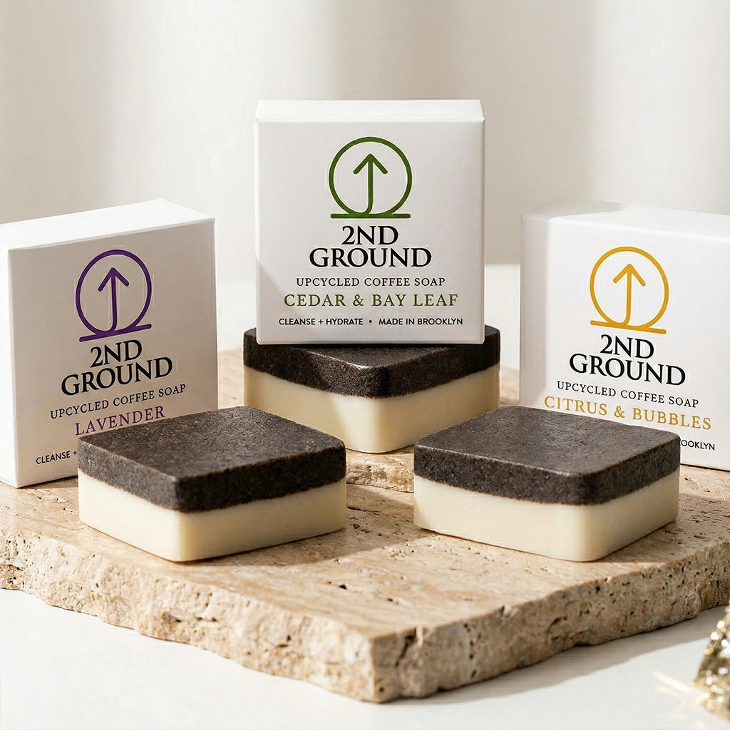 Collection of 2nd Ground upcycled coffee soap bars on a stone surface with branded boxes. comfrey salve for healing arthritis workout recovery drawing salve